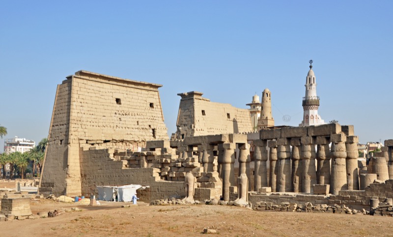 Luxor Temple at dusk with the entrance pylon and obelisk illuminated by floodlights